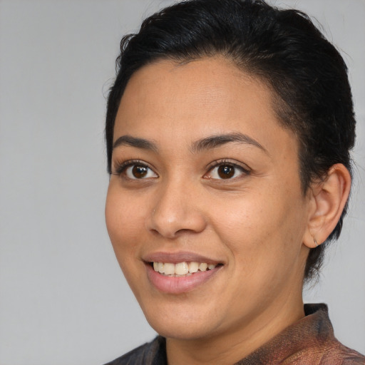 Joyful black young-adult female with medium  brown hair and brown eyes