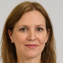 Joyful white adult female with long  brown hair and brown eyes