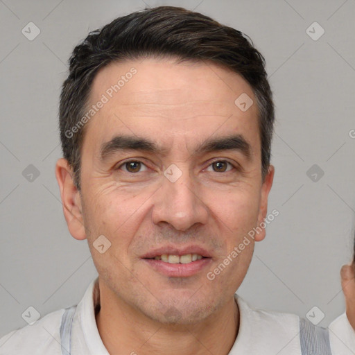 Joyful white adult male with short  black hair and brown eyes