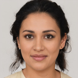 Joyful latino young-adult female with medium  brown hair and brown eyes