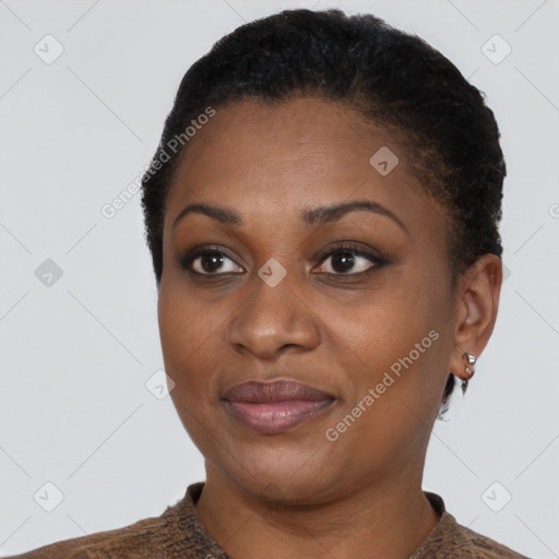 Joyful black young-adult female with short  brown hair and brown eyes