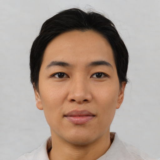 Joyful asian young-adult male with short  black hair and brown eyes