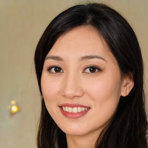 Joyful asian young-adult female with long  brown hair and brown eyes