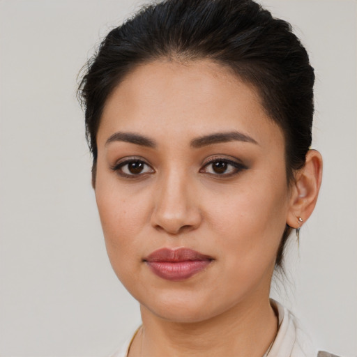 Joyful latino young-adult female with medium  brown hair and brown eyes