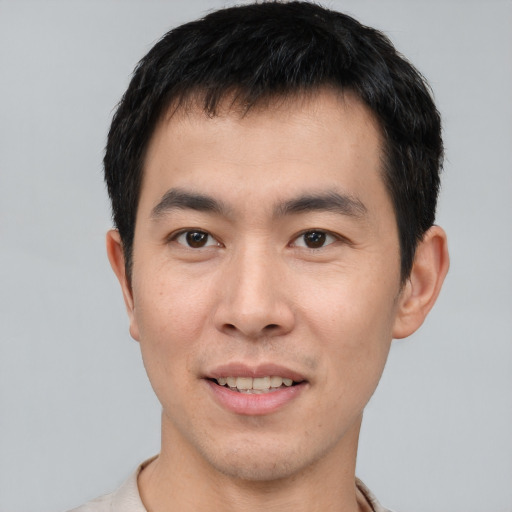 Joyful asian young-adult male with short  black hair and brown eyes