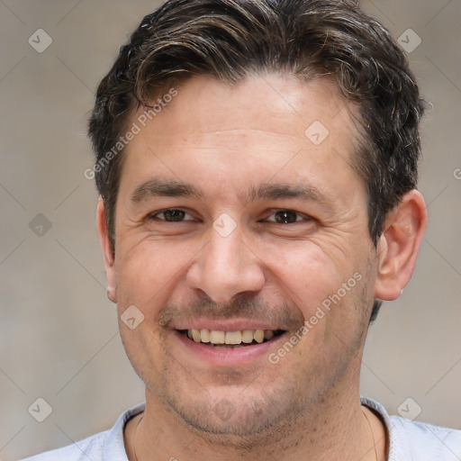 Joyful white adult male with short  brown hair and brown eyes