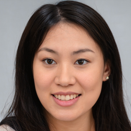Joyful asian young-adult female with long  brown hair and brown eyes