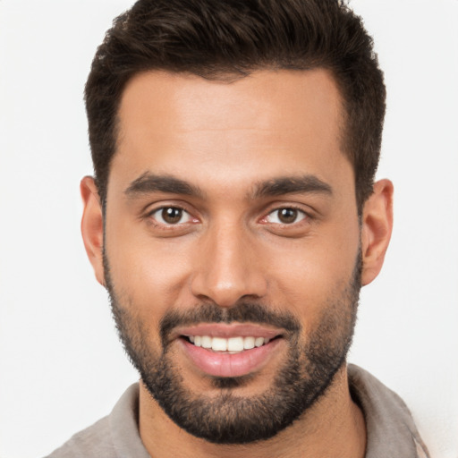 Joyful white young-adult male with short  brown hair and brown eyes