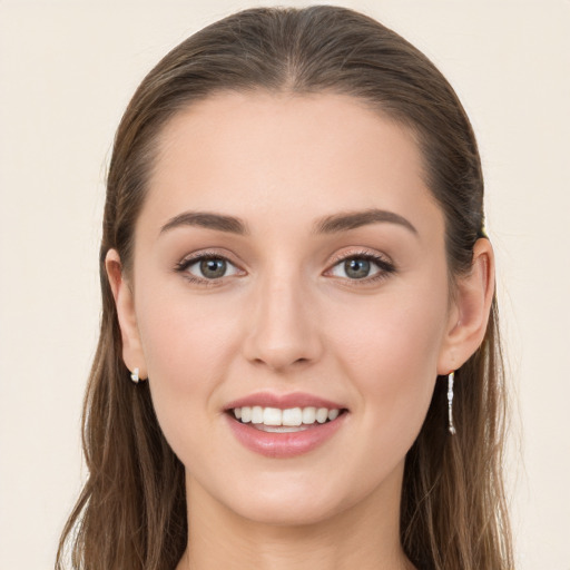 Joyful white young-adult female with long  brown hair and grey eyes