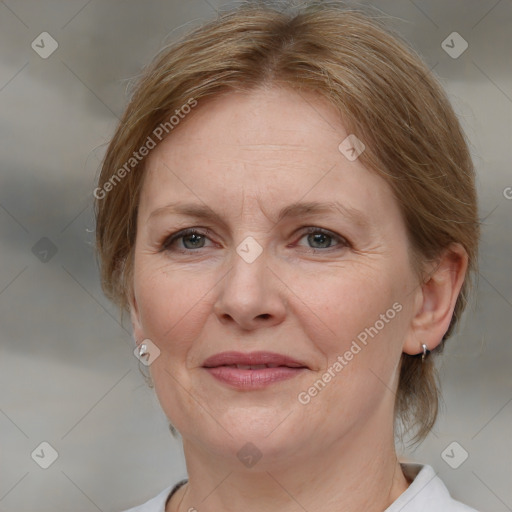 Joyful white adult female with medium  brown hair and blue eyes