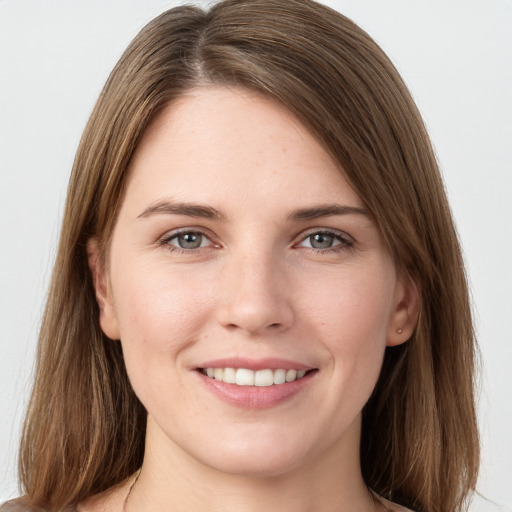 Joyful white young-adult female with long  brown hair and grey eyes