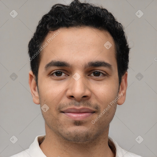 Joyful latino young-adult male with short  black hair and brown eyes