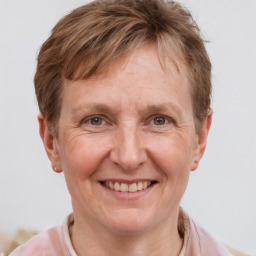 Joyful white adult female with short  brown hair and grey eyes