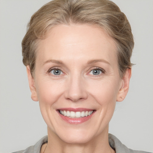 Joyful white adult female with short  brown hair and grey eyes