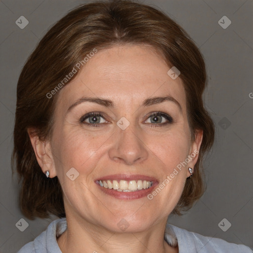 Joyful white adult female with medium  brown hair and blue eyes