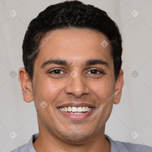 Joyful white young-adult male with short  black hair and brown eyes