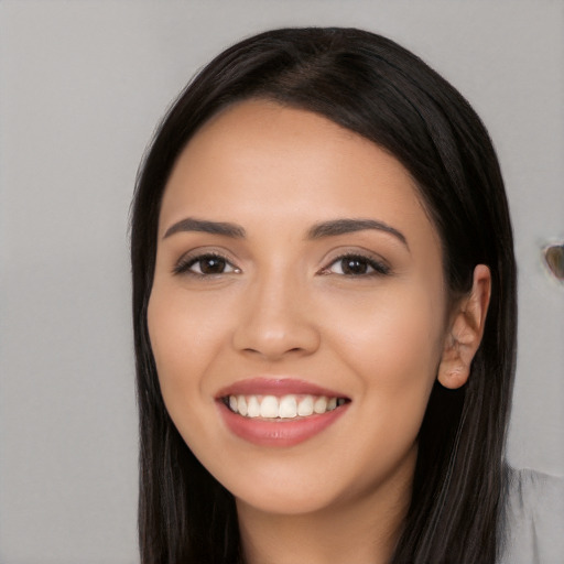 Joyful white young-adult female with long  black hair and brown eyes