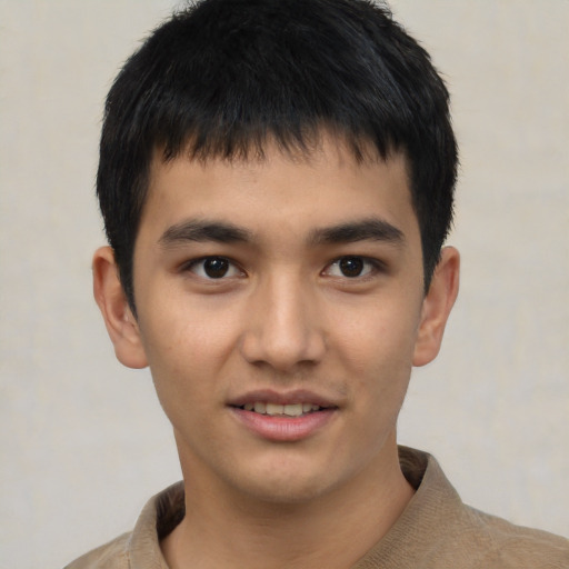 Joyful asian young-adult male with short  brown hair and brown eyes