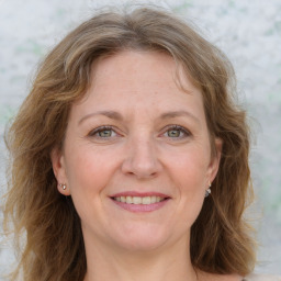 Joyful white adult female with medium  brown hair and blue eyes