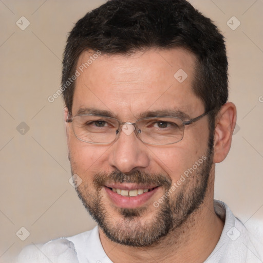 Joyful white adult male with short  brown hair and brown eyes