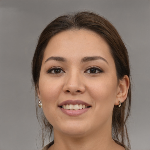 Joyful white young-adult female with medium  brown hair and brown eyes