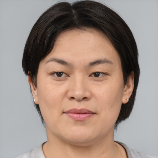 Joyful asian young-adult female with medium  brown hair and brown eyes