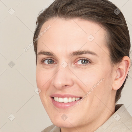 Joyful white adult female with short  brown hair and grey eyes