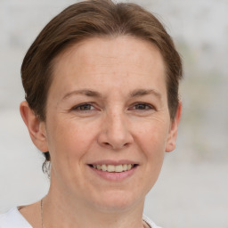 Joyful white adult female with short  brown hair and grey eyes