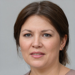 Joyful white young-adult female with medium  brown hair and grey eyes