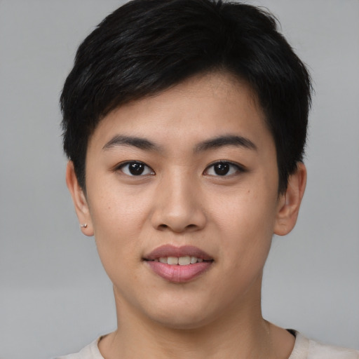 Joyful asian young-adult female with short  black hair and brown eyes
