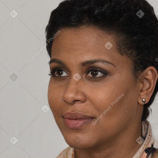 Joyful black young-adult female with short  black hair and brown eyes