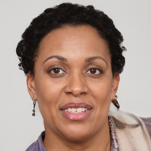 Joyful black adult female with short  brown hair and brown eyes
