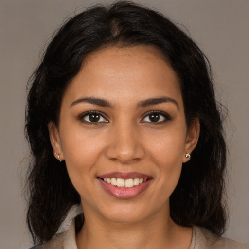 Joyful latino young-adult female with long  brown hair and brown eyes