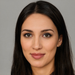 Joyful latino young-adult female with long  brown hair and brown eyes