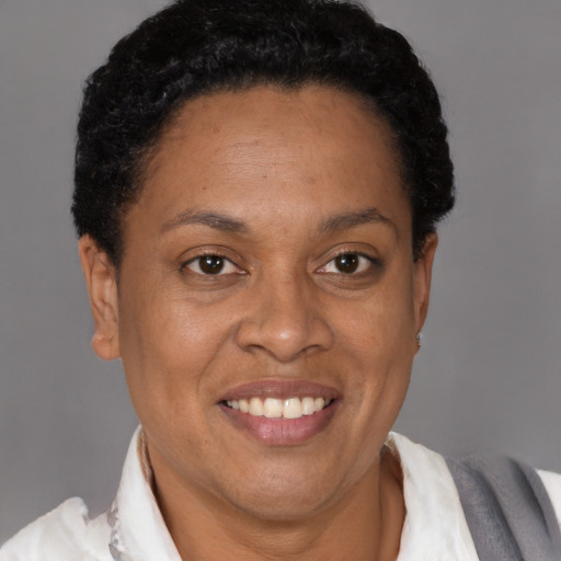 Joyful latino adult female with short  brown hair and brown eyes