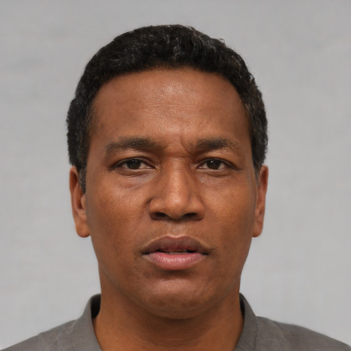 Neutral latino adult male with short  black hair and brown eyes
