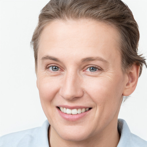 Joyful white adult female with short  brown hair and grey eyes