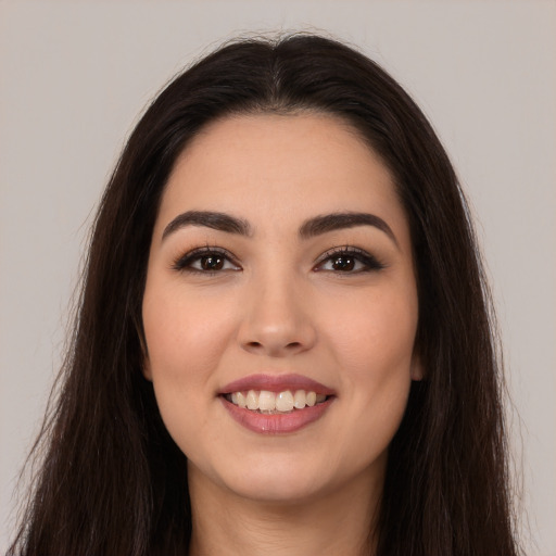 Joyful white young-adult female with long  brown hair and brown eyes