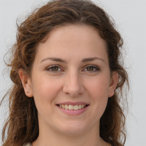 Joyful white young-adult female with long  brown hair and green eyes