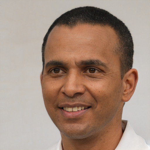 Joyful latino adult male with short  black hair and brown eyes
