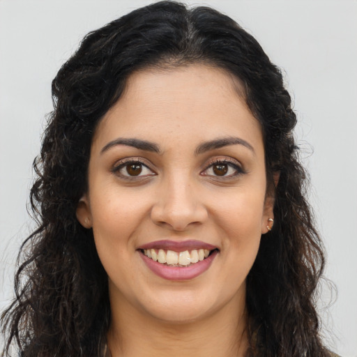 Joyful latino young-adult female with long  brown hair and brown eyes