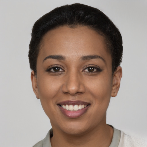 Joyful latino young-adult female with short  black hair and brown eyes