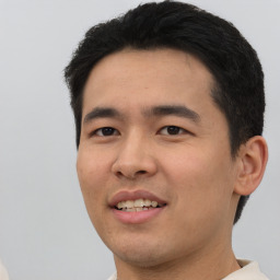 Joyful asian young-adult male with short  black hair and brown eyes