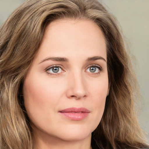 Joyful white young-adult female with long  brown hair and green eyes