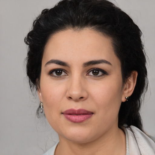 Joyful latino young-adult female with medium  black hair and brown eyes