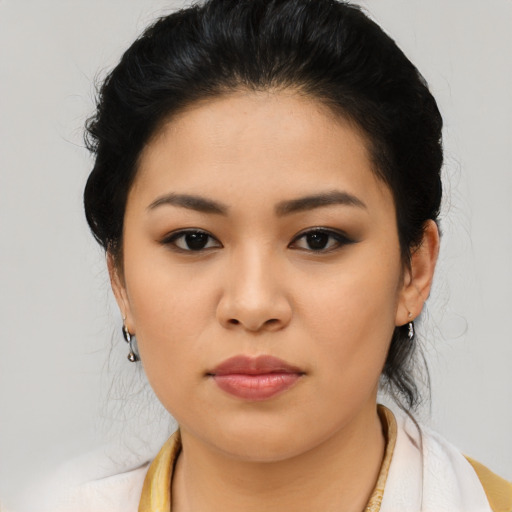Joyful latino young-adult female with medium  black hair and brown eyes