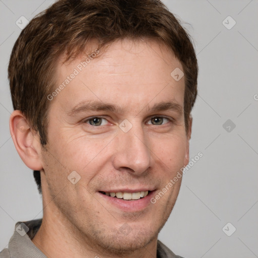 Joyful white adult male with short  brown hair and grey eyes