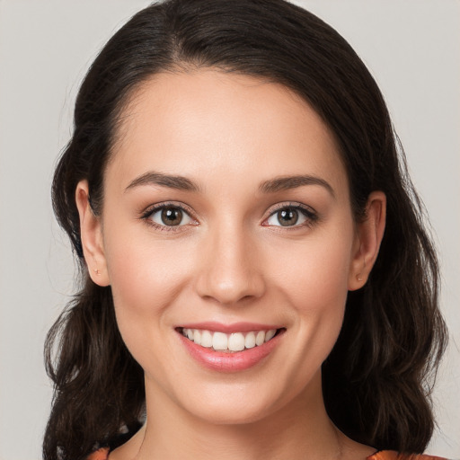 Joyful white young-adult female with medium  brown hair and brown eyes