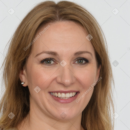 Joyful white adult female with long  brown hair and brown eyes