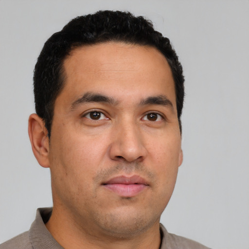 Neutral latino young-adult male with short  brown hair and brown eyes